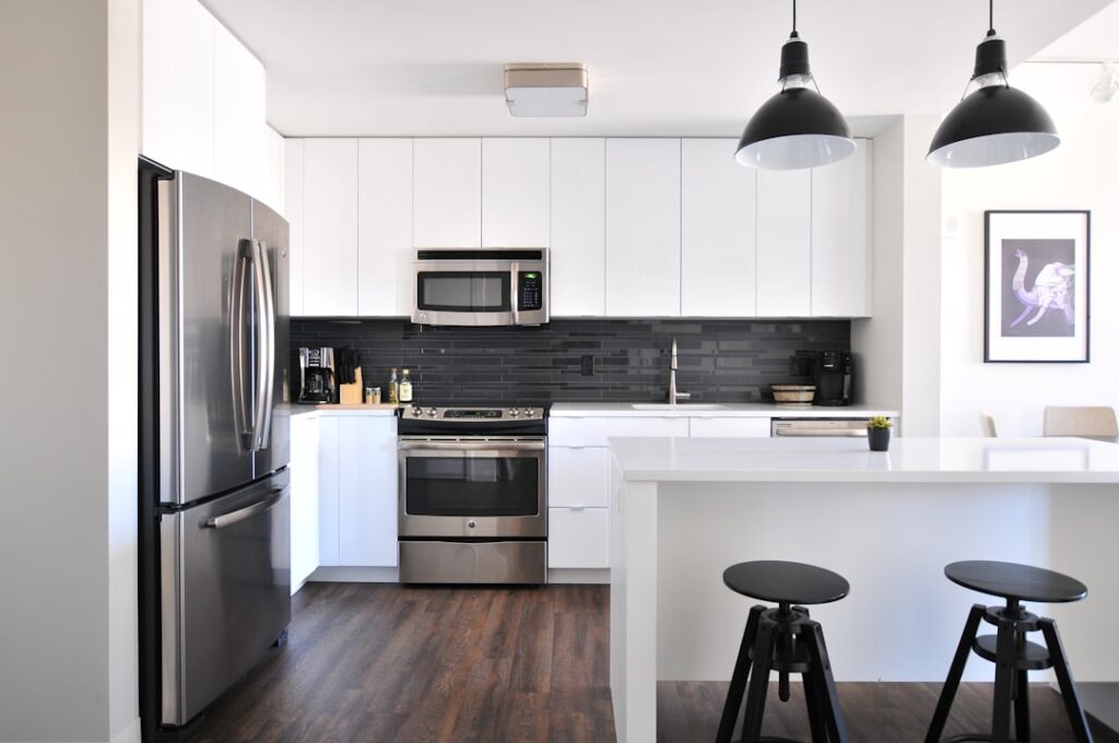 White kitchen with counters and household appliances
