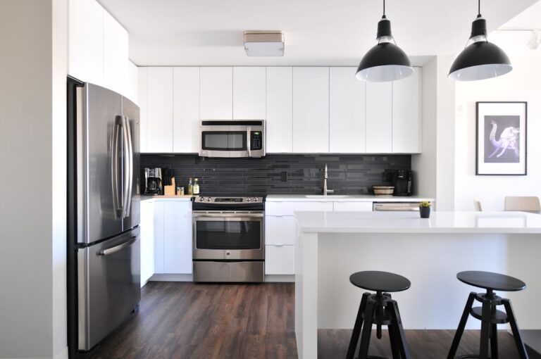 White kitchen with counters and household appliances