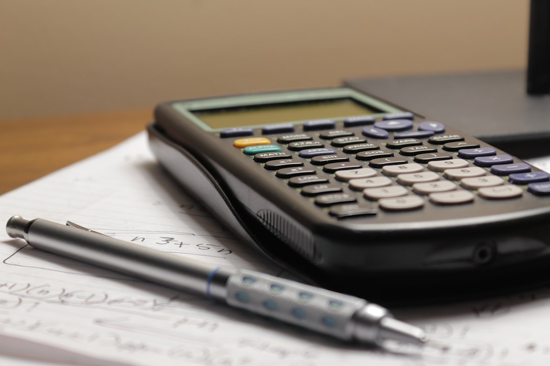 Calculator and pen on paper