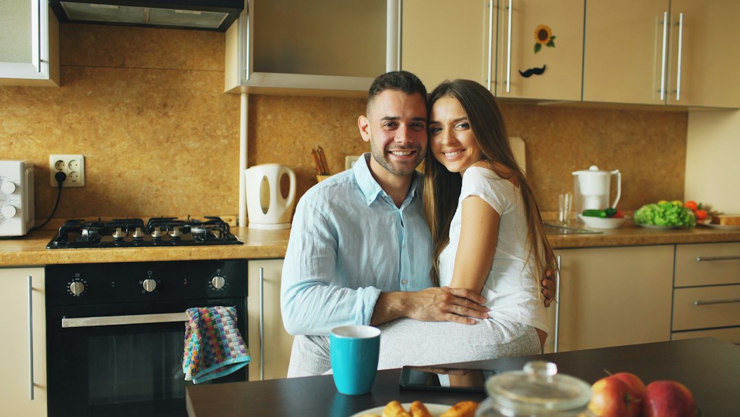 Couple together in their apartment kitchen